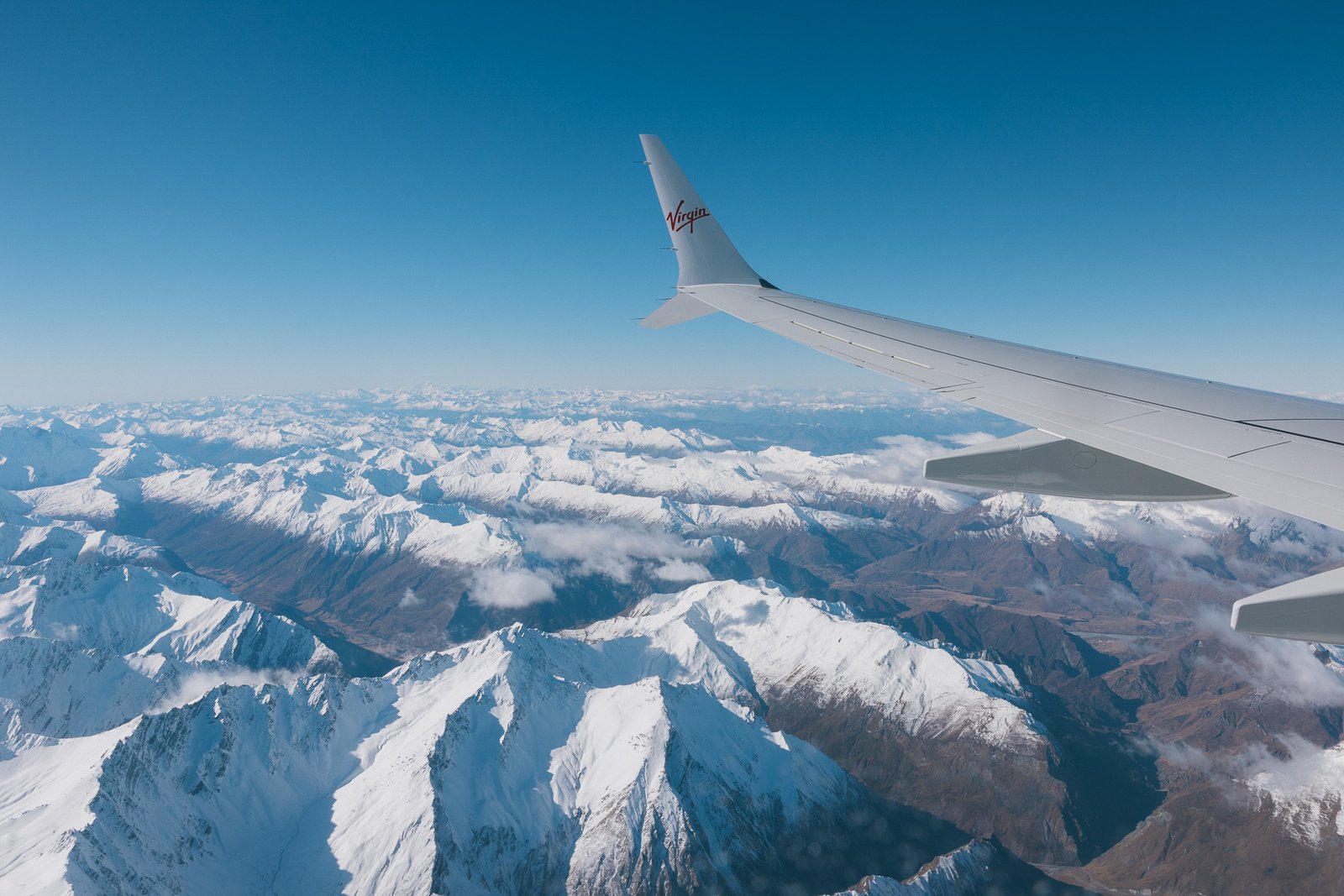 Snow-capped mountains flying into Queenstown in winter